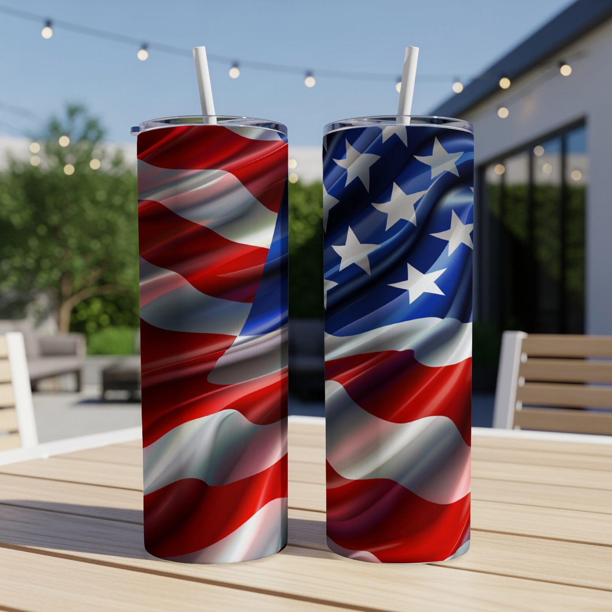 Two American flag tumblers with straws on a wooden table.