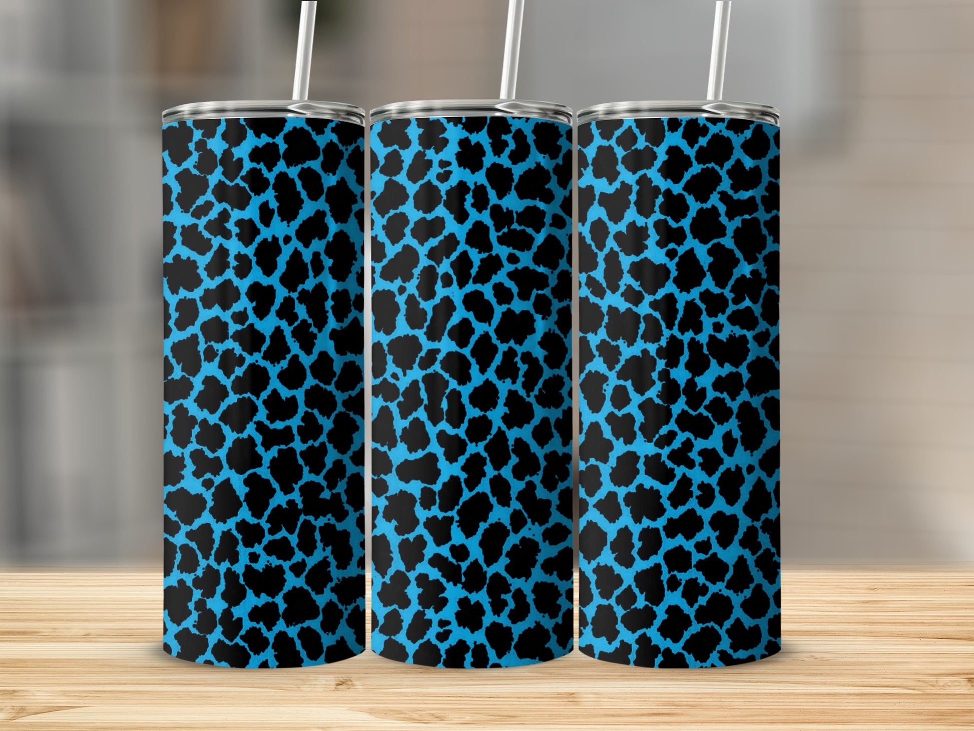 Three tumblers with a black and bright blue leopard print pattern.