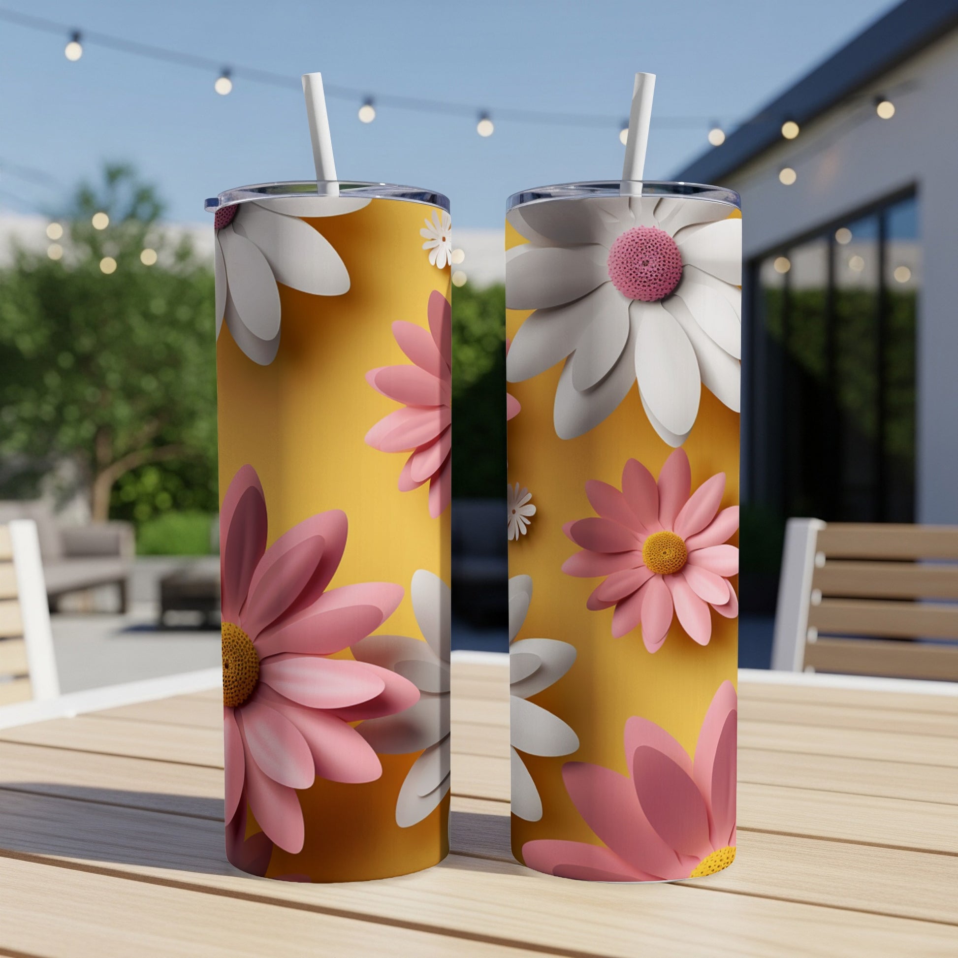 Two tumblers with pink and white daisies on yellow background.