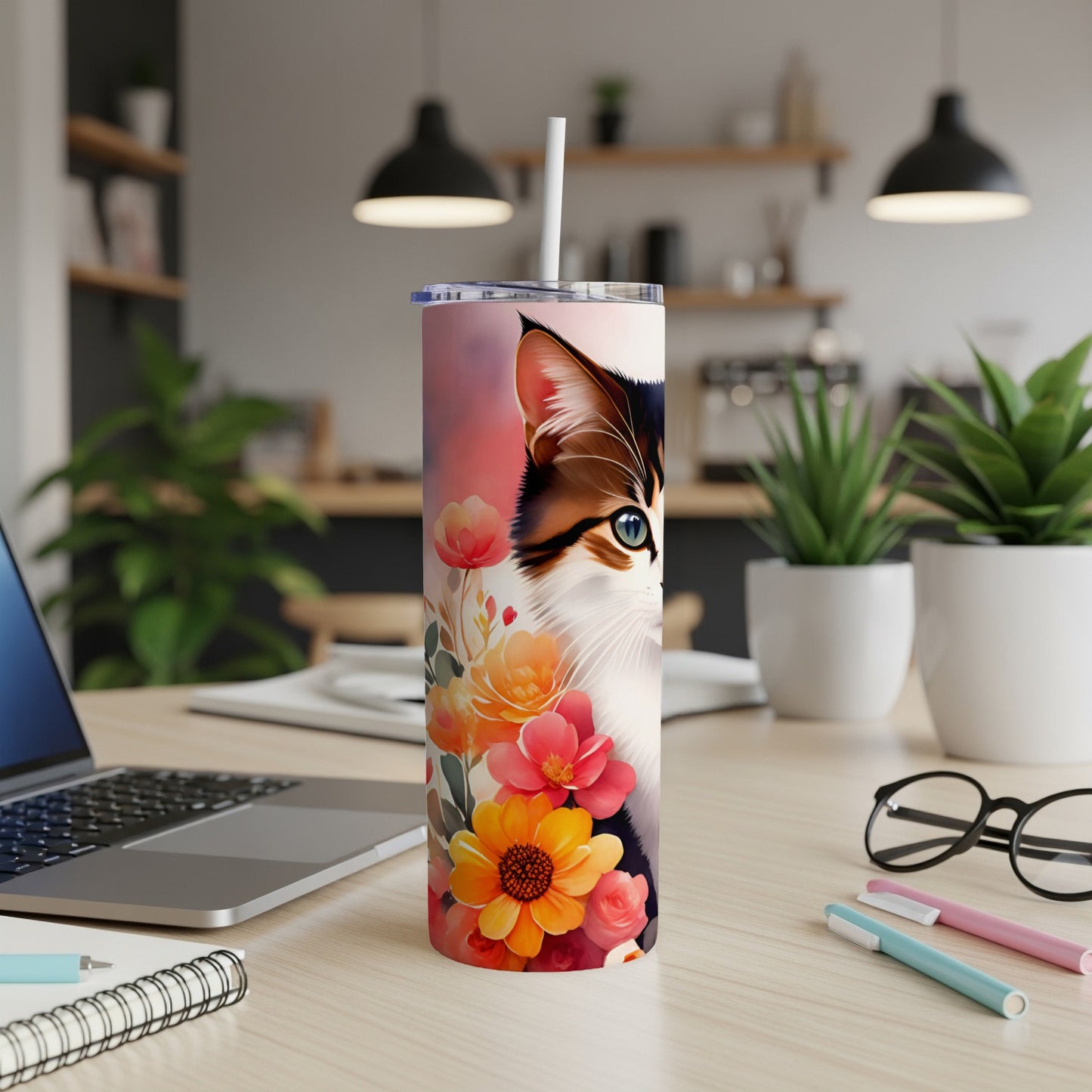 Cat and floral design on a white tumbler with a straw.