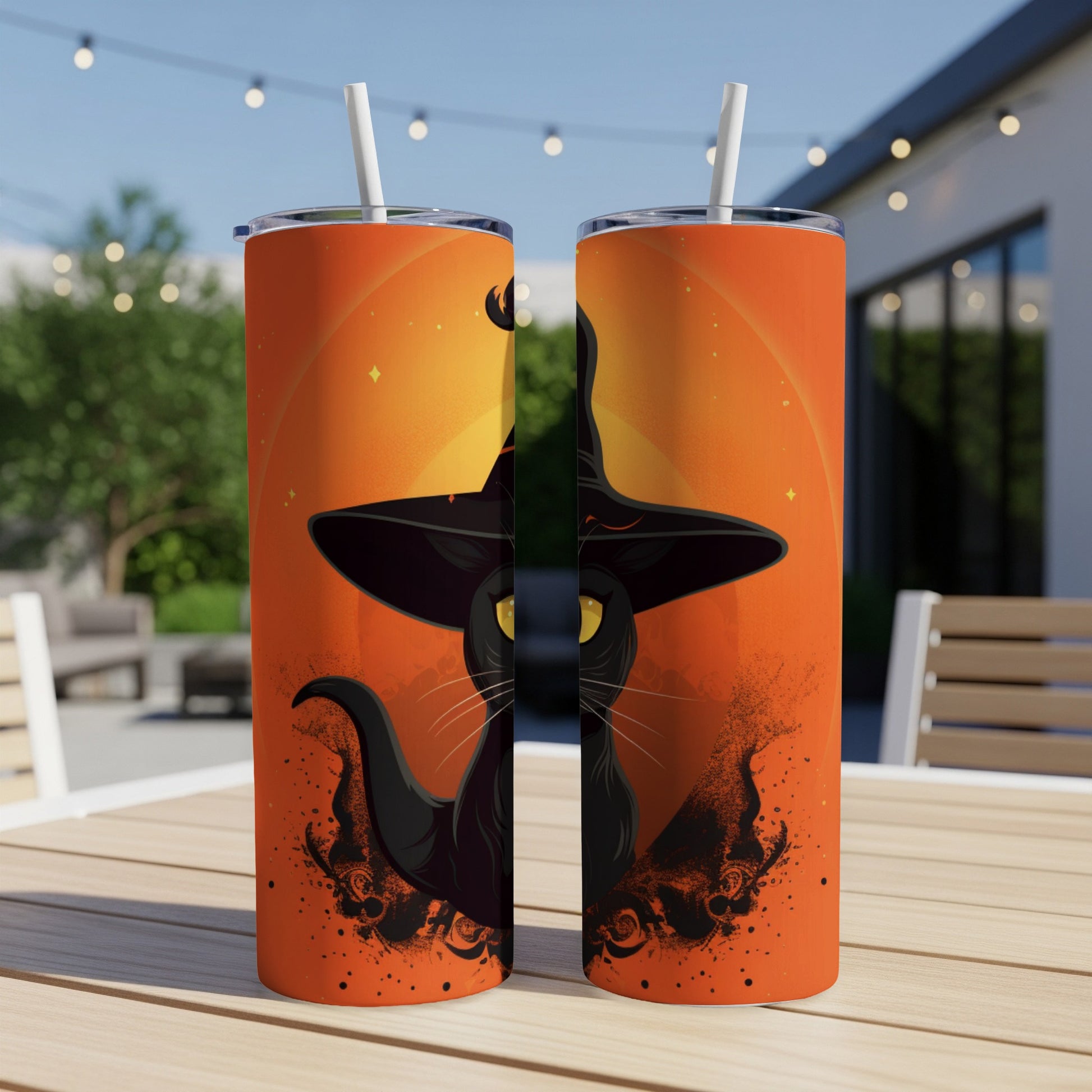 Two tumblers with a black witch cat illustration on an orange gradient background.