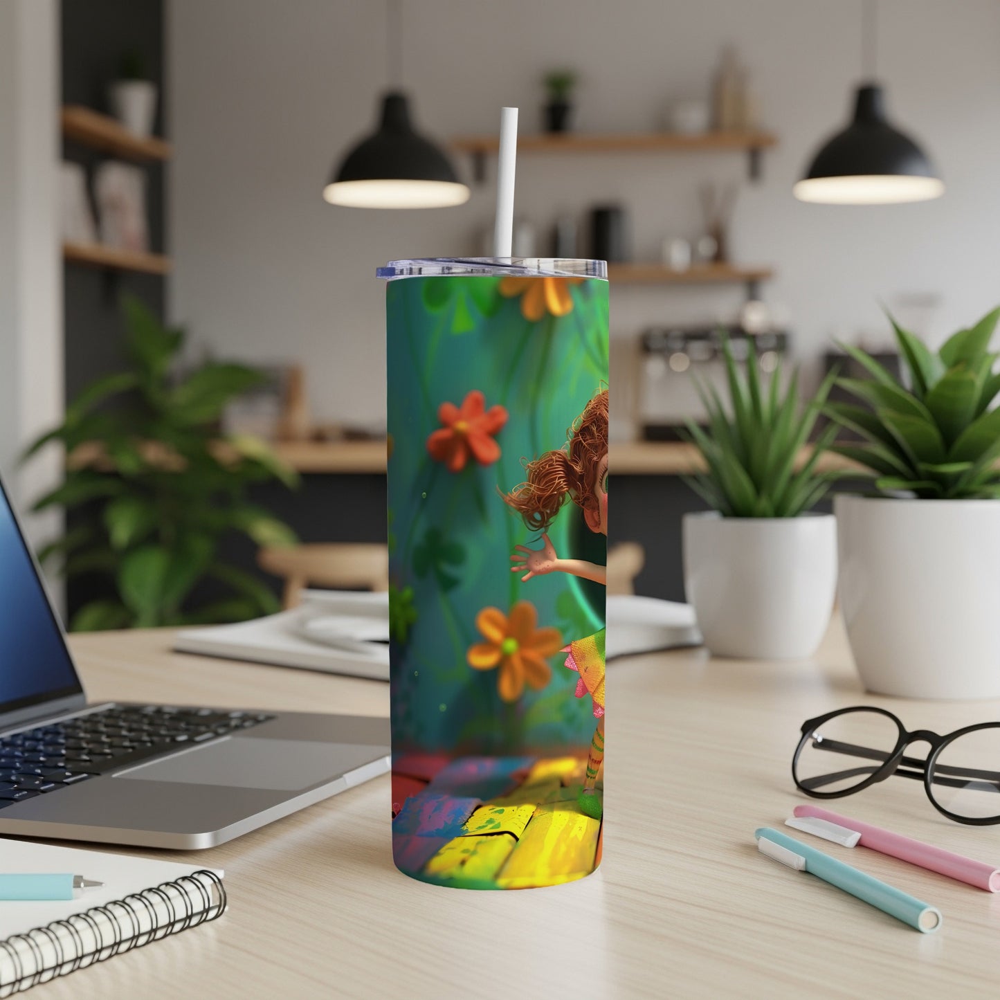 Tall tumbler with cartoon girl and floral pattern, standing on colorful paint splatters.