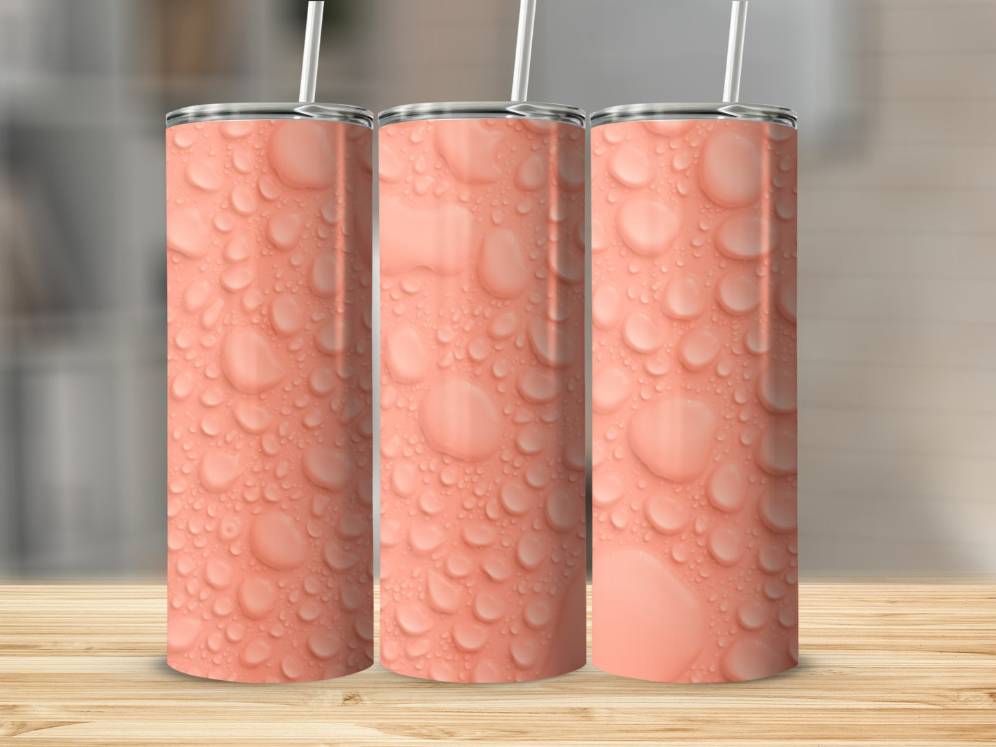 Three seamless tumblers with a pattern of water droplets on a wooden surface.