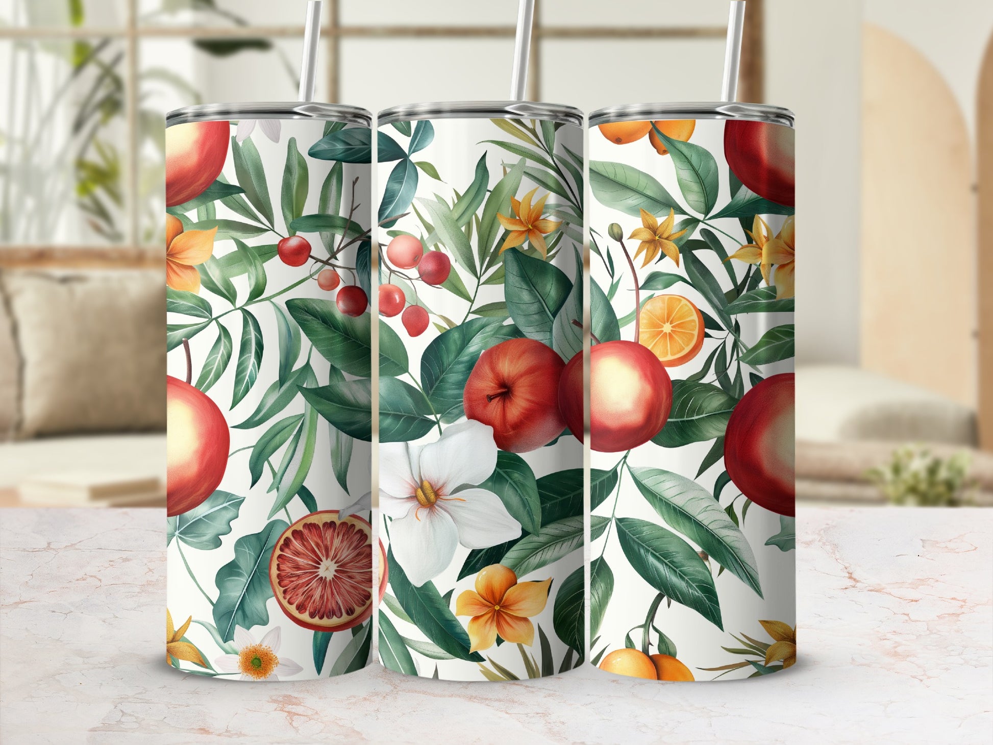 Three tumblers with a fruit and floral pattern on a light background.