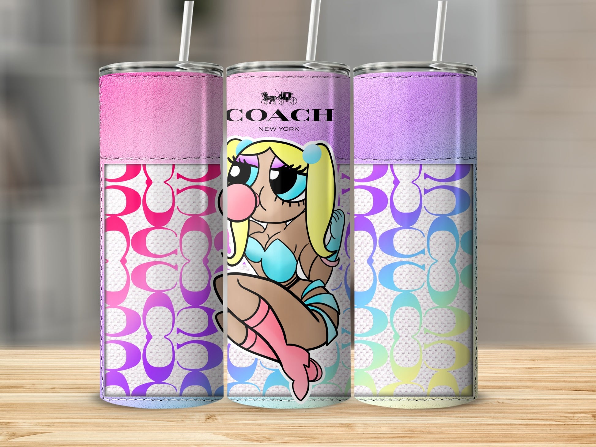 Three tumblers featuring a stylized cartoon character and the Coach logo.