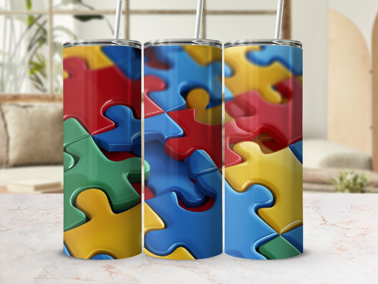 Three colorful puzzle piece tumblers with straws.