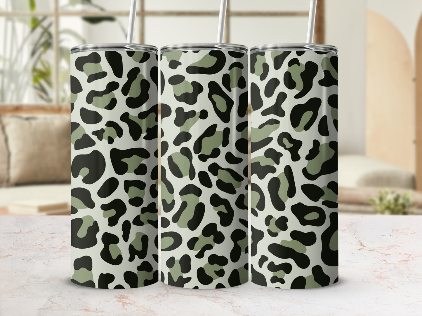 Three tumblers with a camouflage leopard print pattern and gray straws.