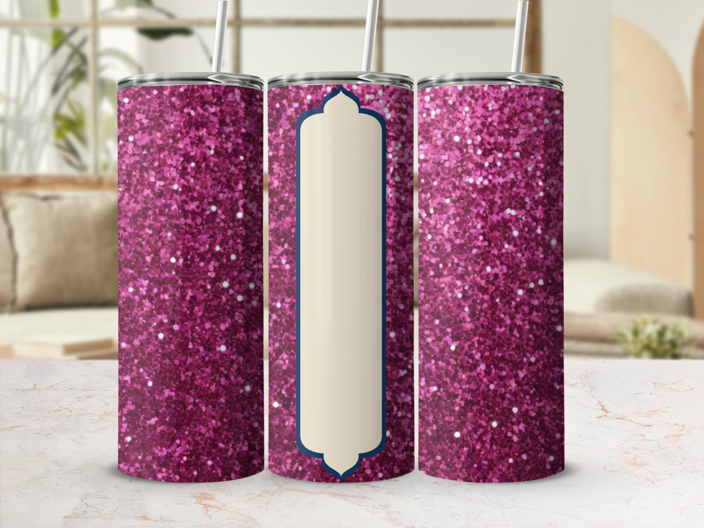 Pink glitter tumbler with a blank ivory label against a blurred background.