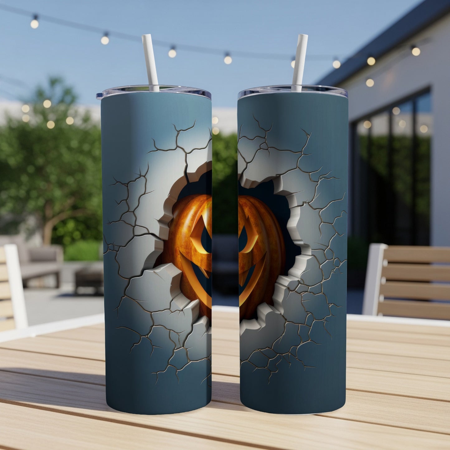 Two tumblers with cracked texture revealing a carved Halloween pumpkin face.