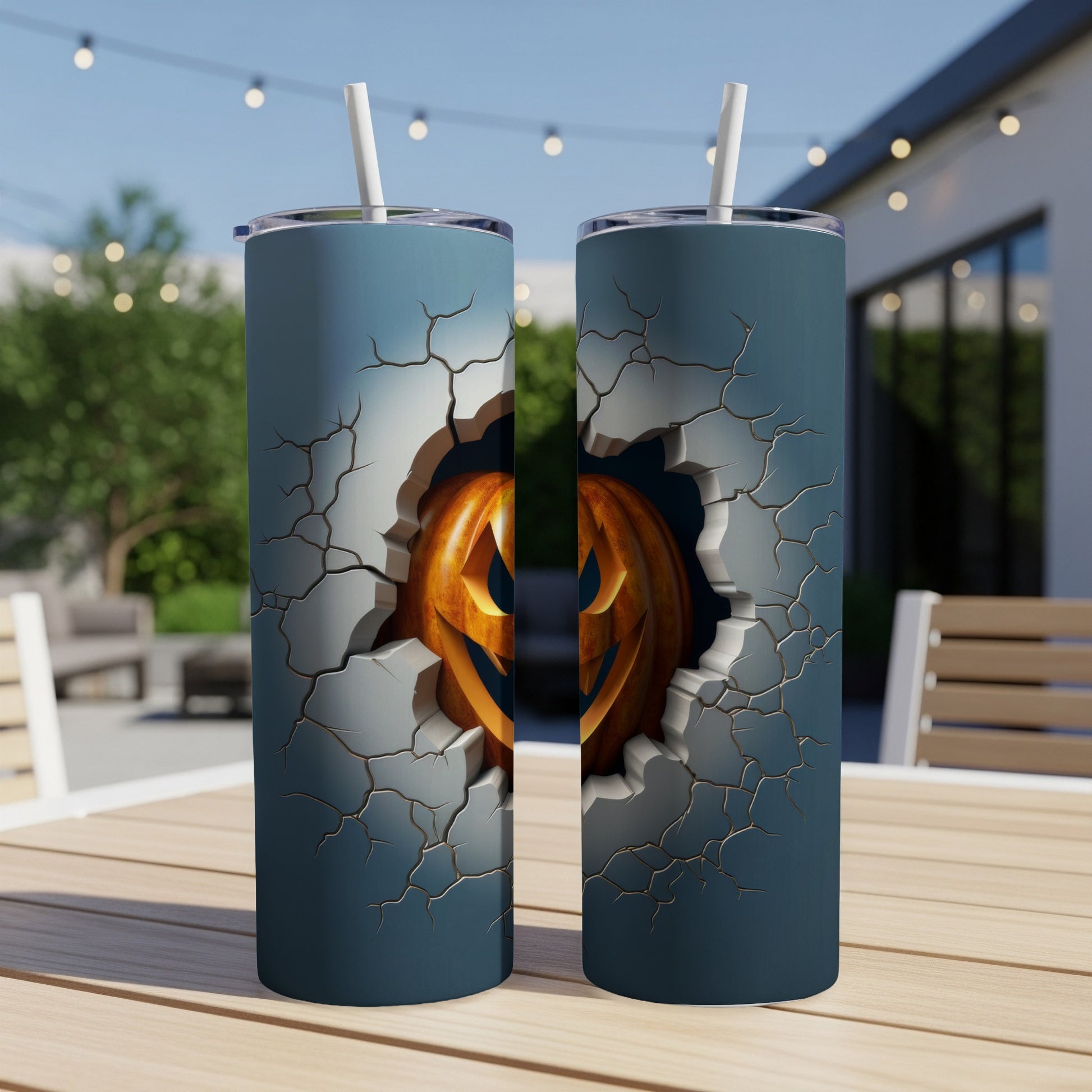 Two tumblers with cracked texture revealing a carved Halloween pumpkin face.