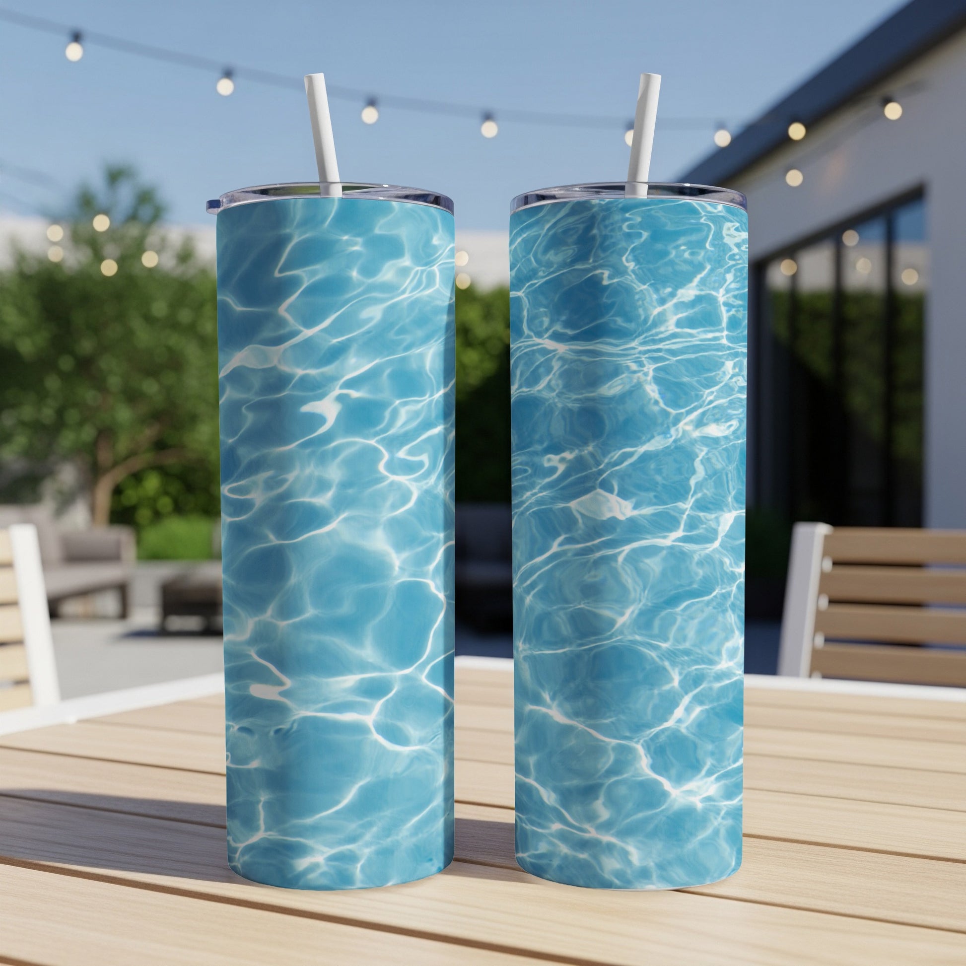 Two tall tumblers with a water ripple pattern sit on a wooden table.