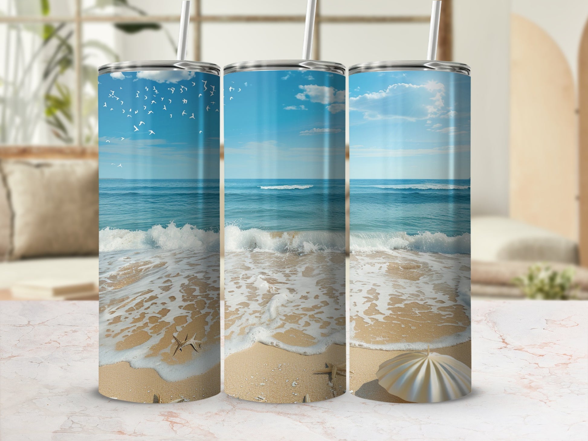 Three tumblers featuring a beach scene with seagulls and a seashell.
