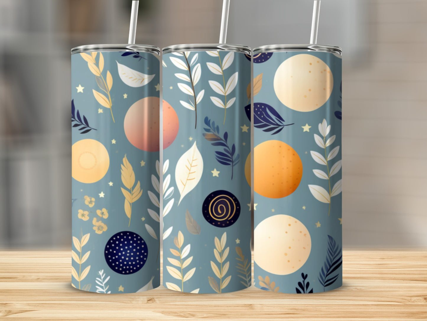 Three tumblers with celestial moon and leaf patterns.