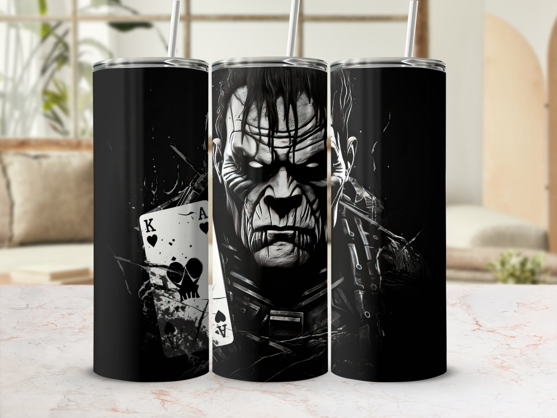 Three tumblers featuring a monster illustration and playing cards.