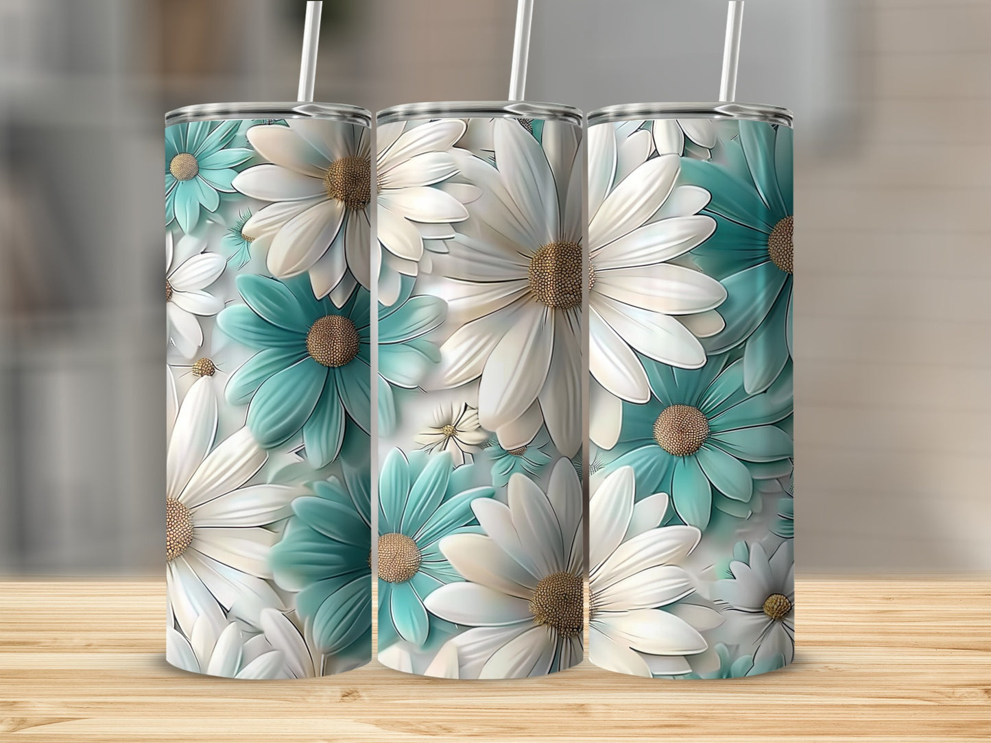 Three tumblers with a repeating pattern of white and teal daisies.