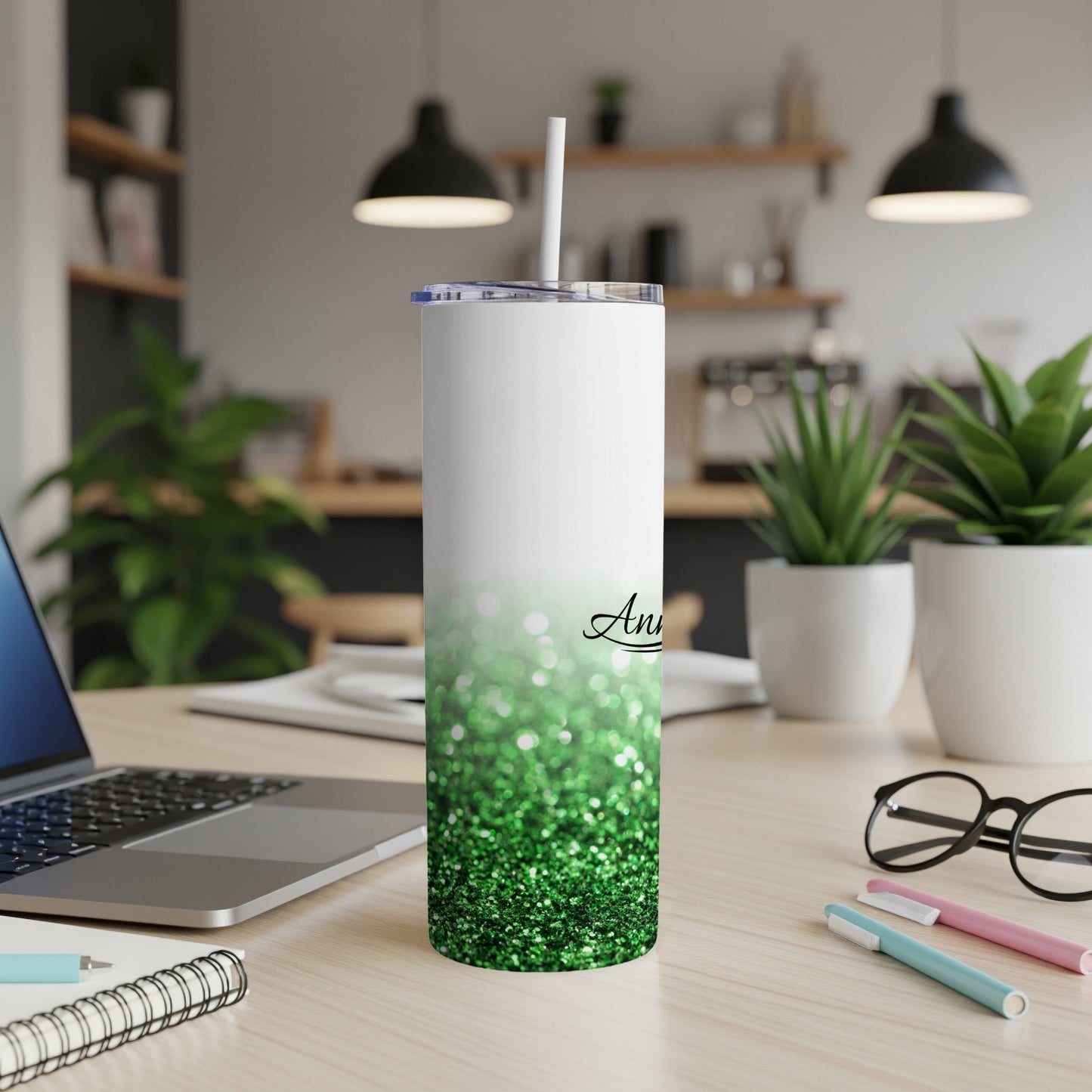 White tumbler with green glitter ombre, straw, and cursive name.