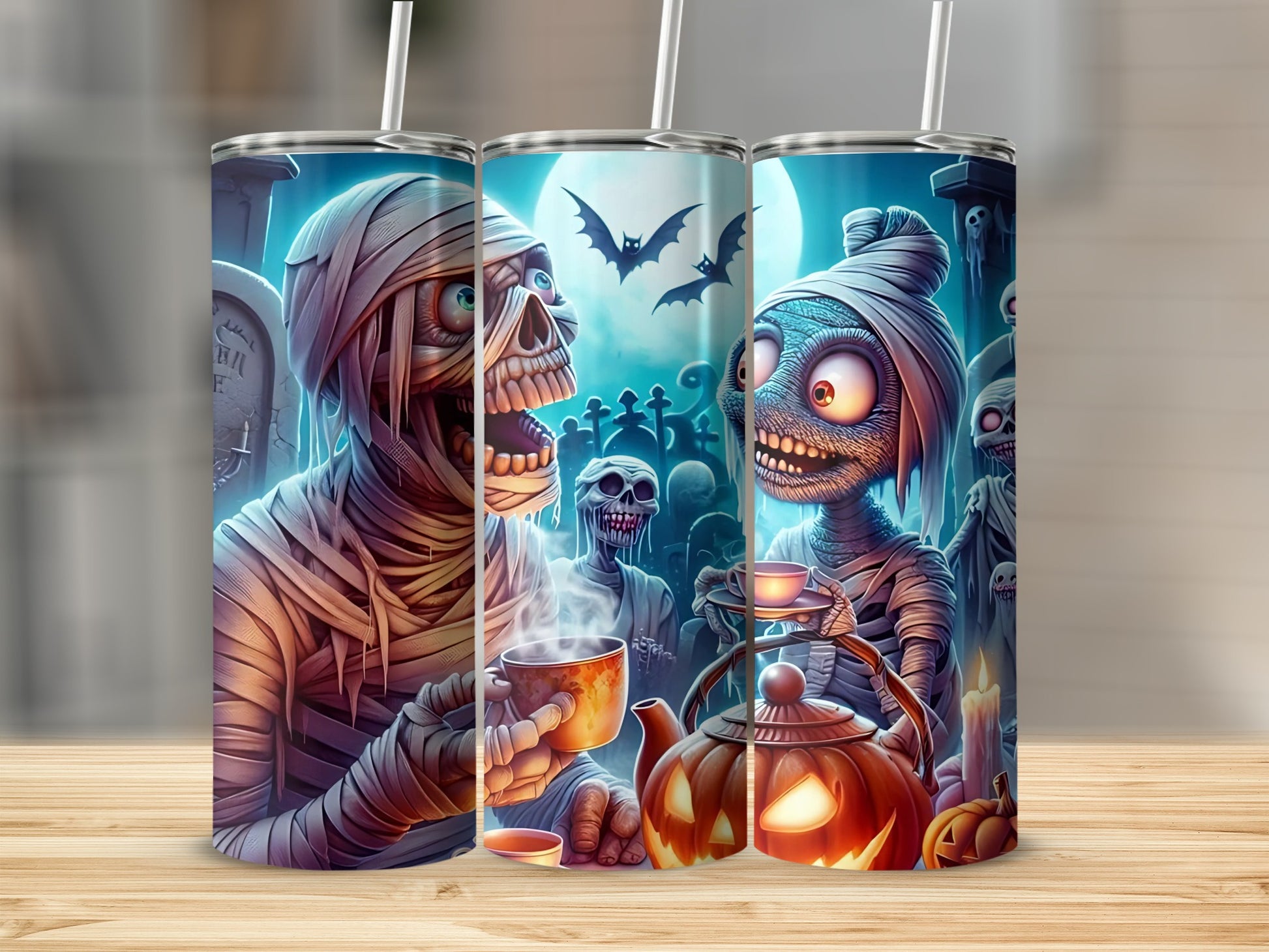 Halloween tumblers featuring mummies, skeletons, and pumpkins with a graveyard background.