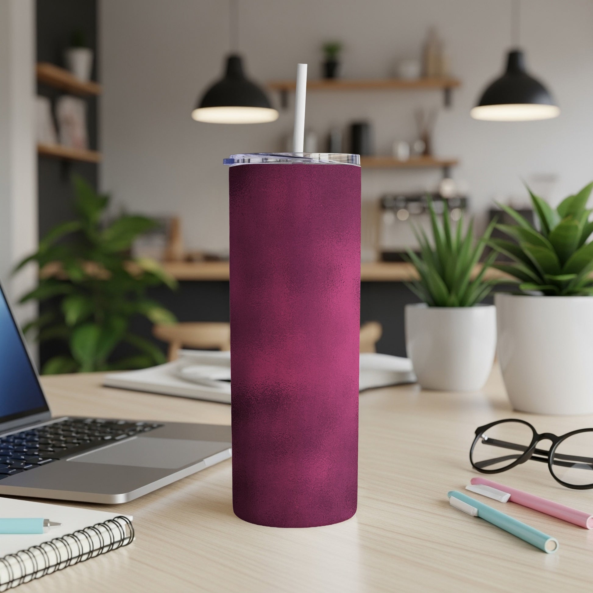 Matte berry textured tumbler with straw on a desk.