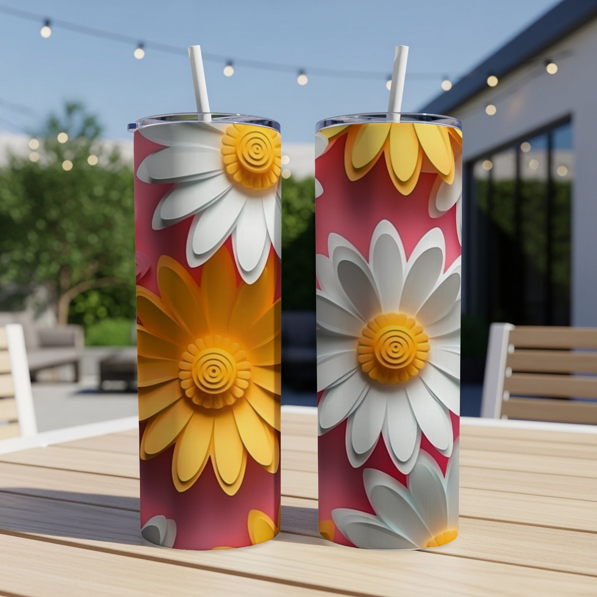 Two tumblers with a floral daisy design on a wooden table.