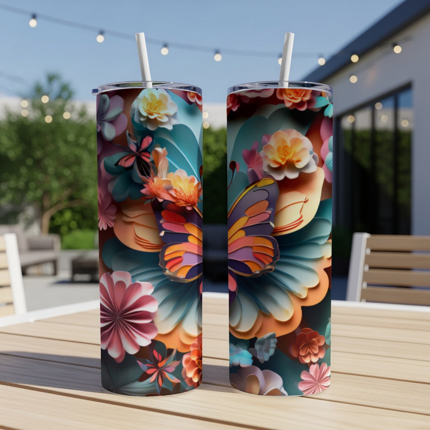 Two tumblers with colorful floral and butterfly designs on a wooden table.