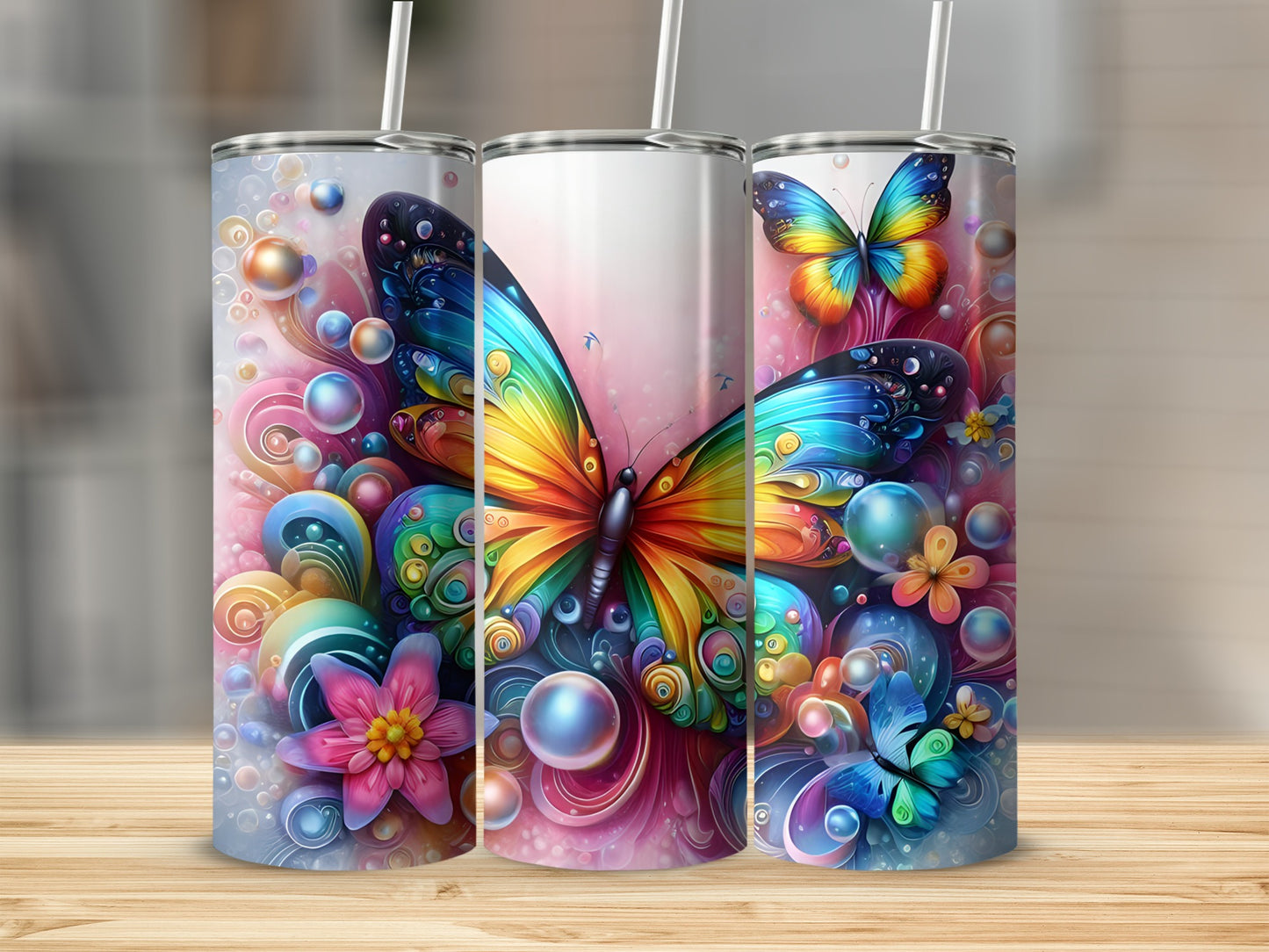 Three tumblers with colorful butterflies and floral designs.