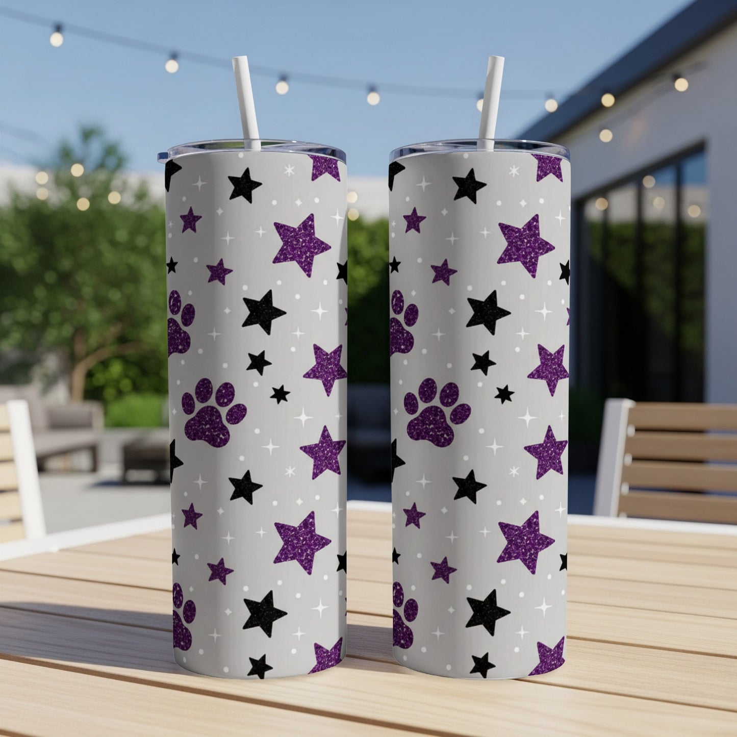 Two tall tumblers with purple paw prints and gray stars on a light gray background.