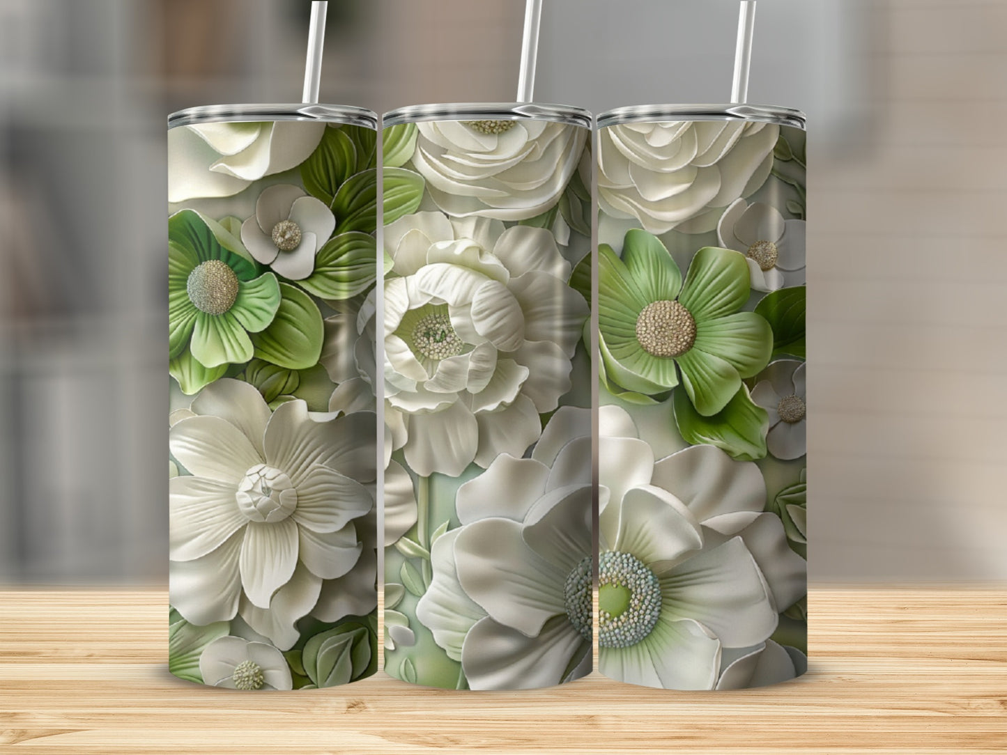 Three white tumblers with embossed white and green floral patterns.