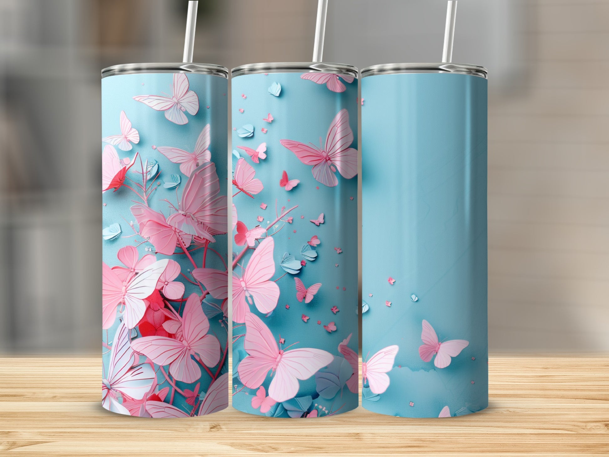 Blue tumbler with pink butterflies and floral accents.