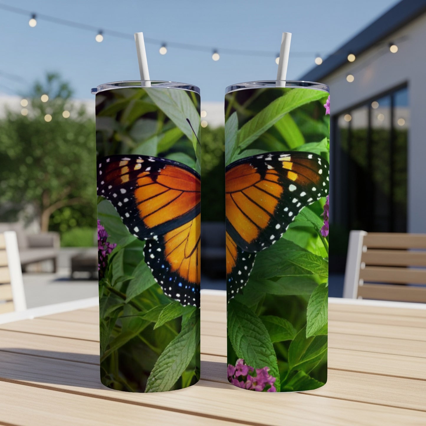 Monarch butterfly with black spots on orange wings on green leaves.