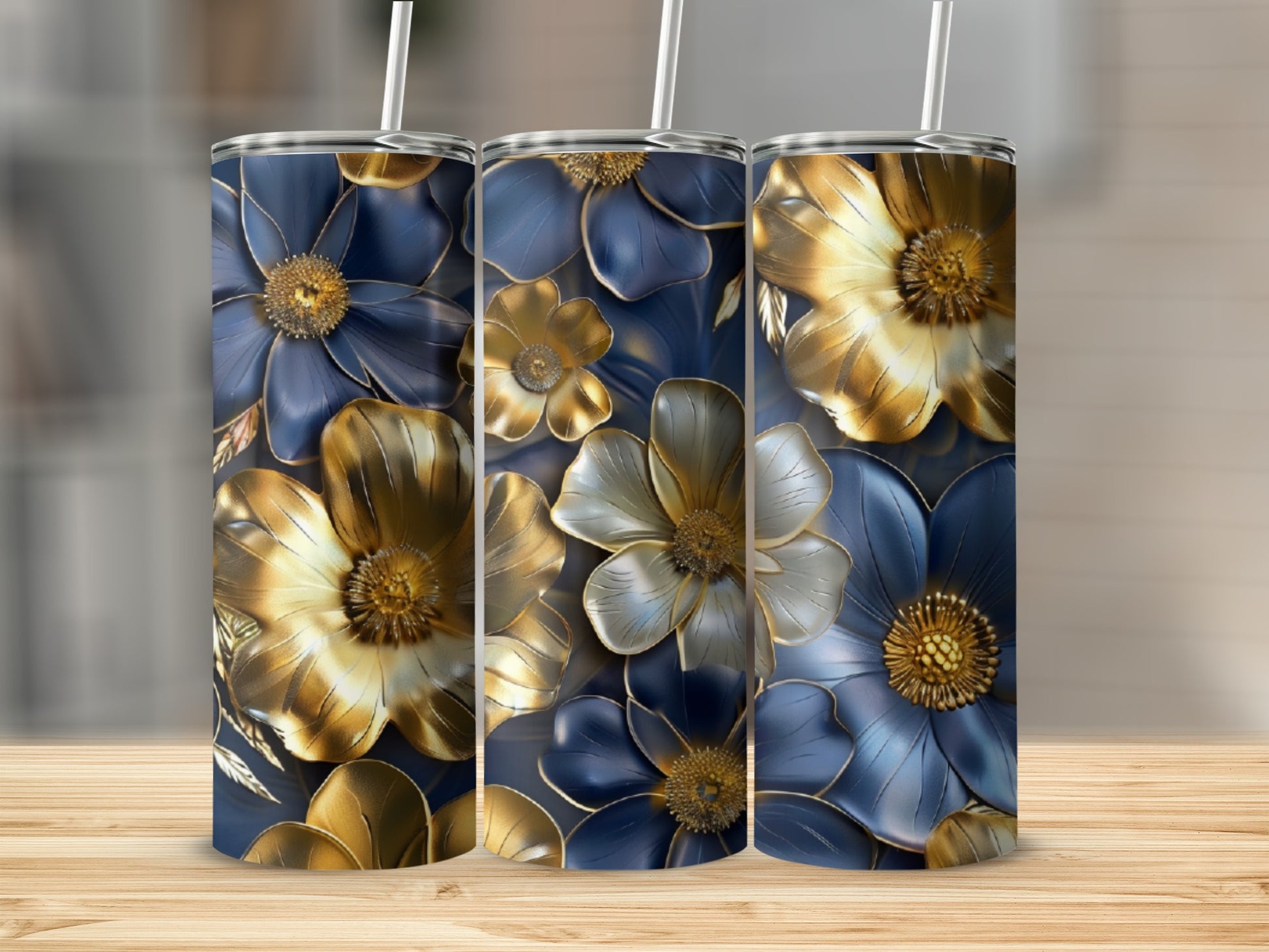 Three dark blue tumblers with gold and blue floral patterns.