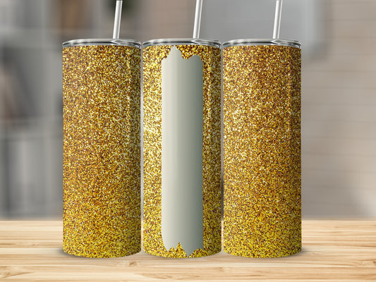 Three glittery gold tumblers with white straws on a wooden surface.