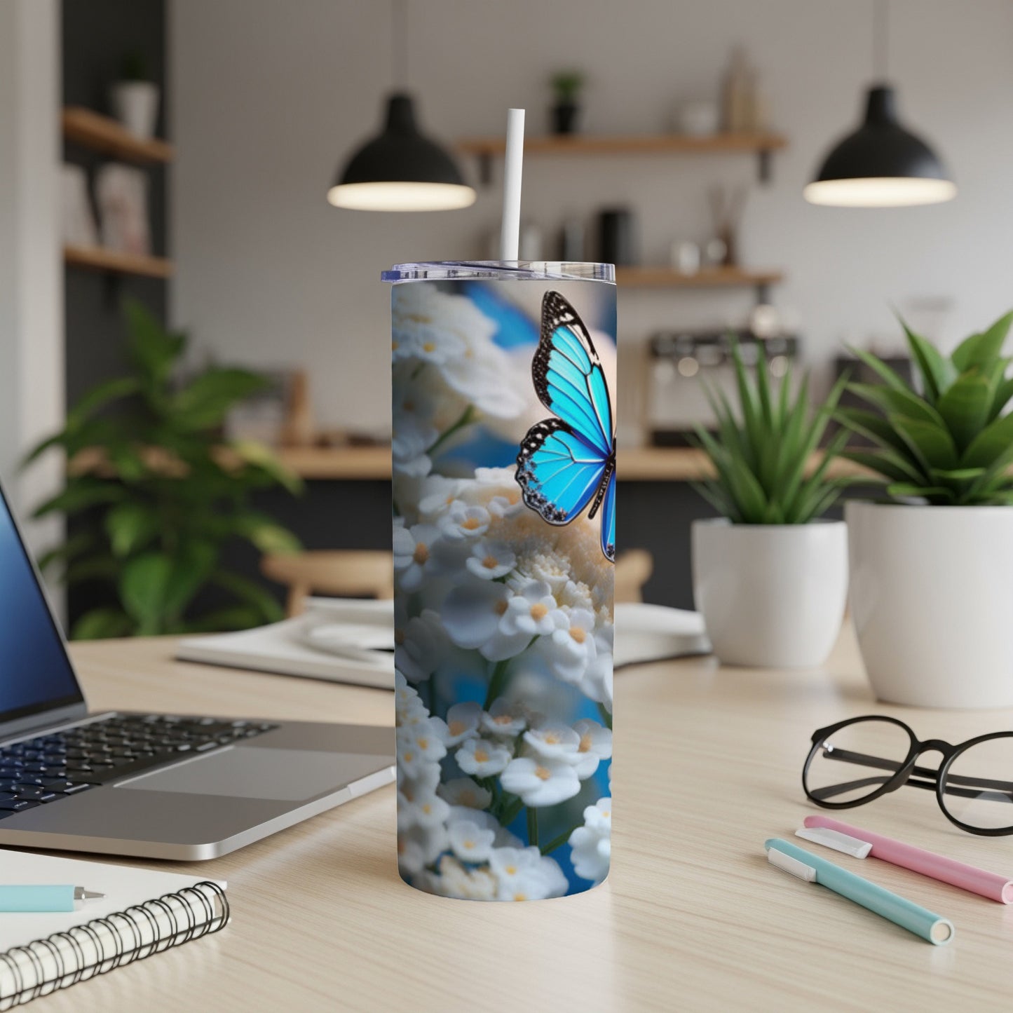 Blue butterfly on white flowers on a white tumbler with a straw.