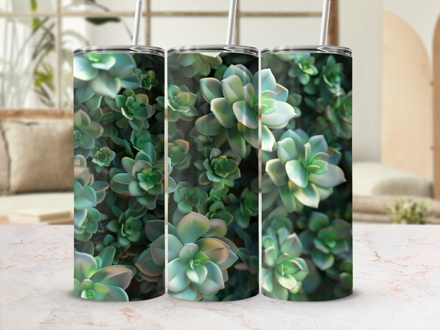 Three tumblers with a close-up succulent plant pattern on a marble countertop.