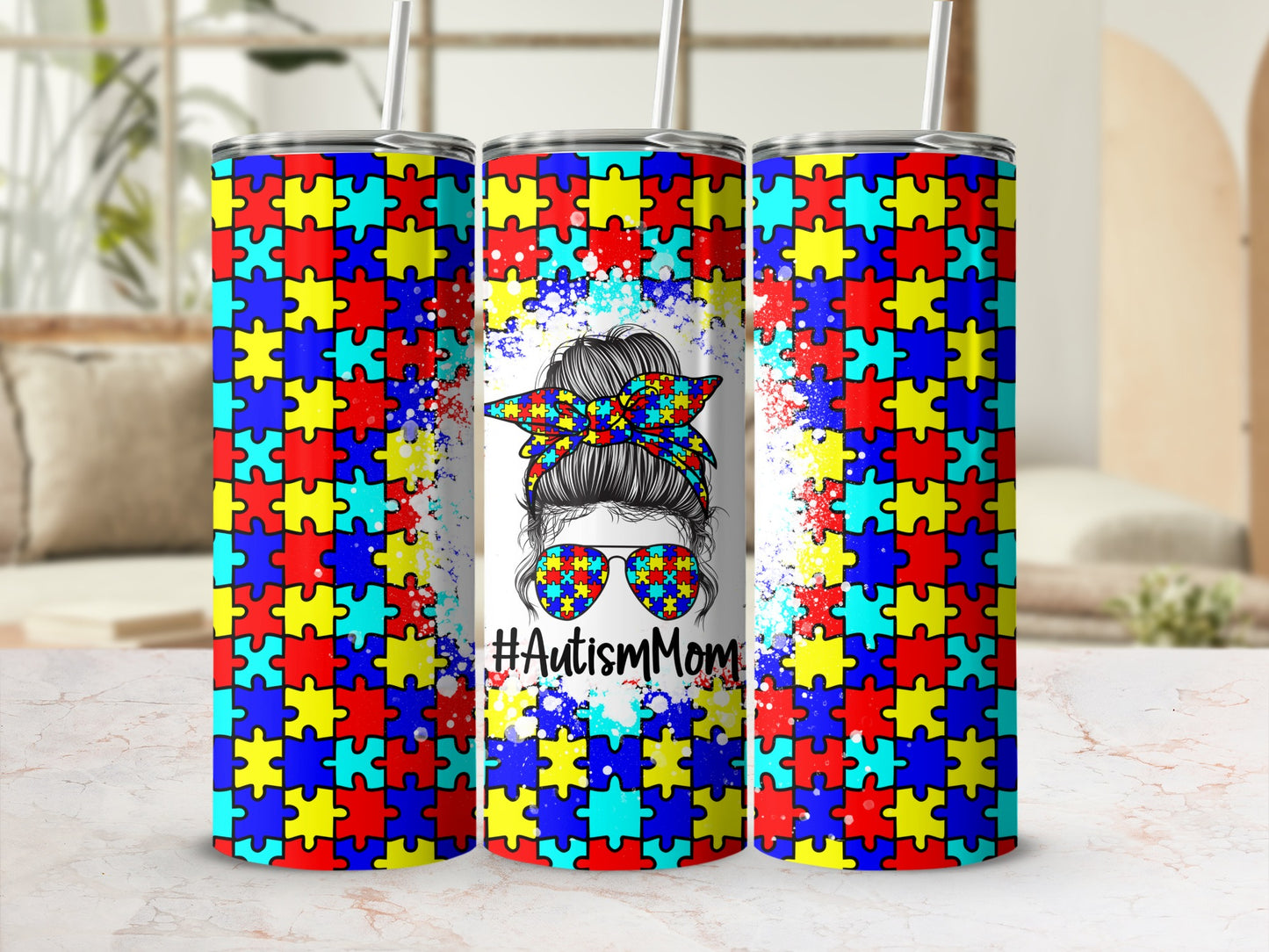 Tumbler with autism puzzle piece pattern, sunglasses, and #AutismMom text.
