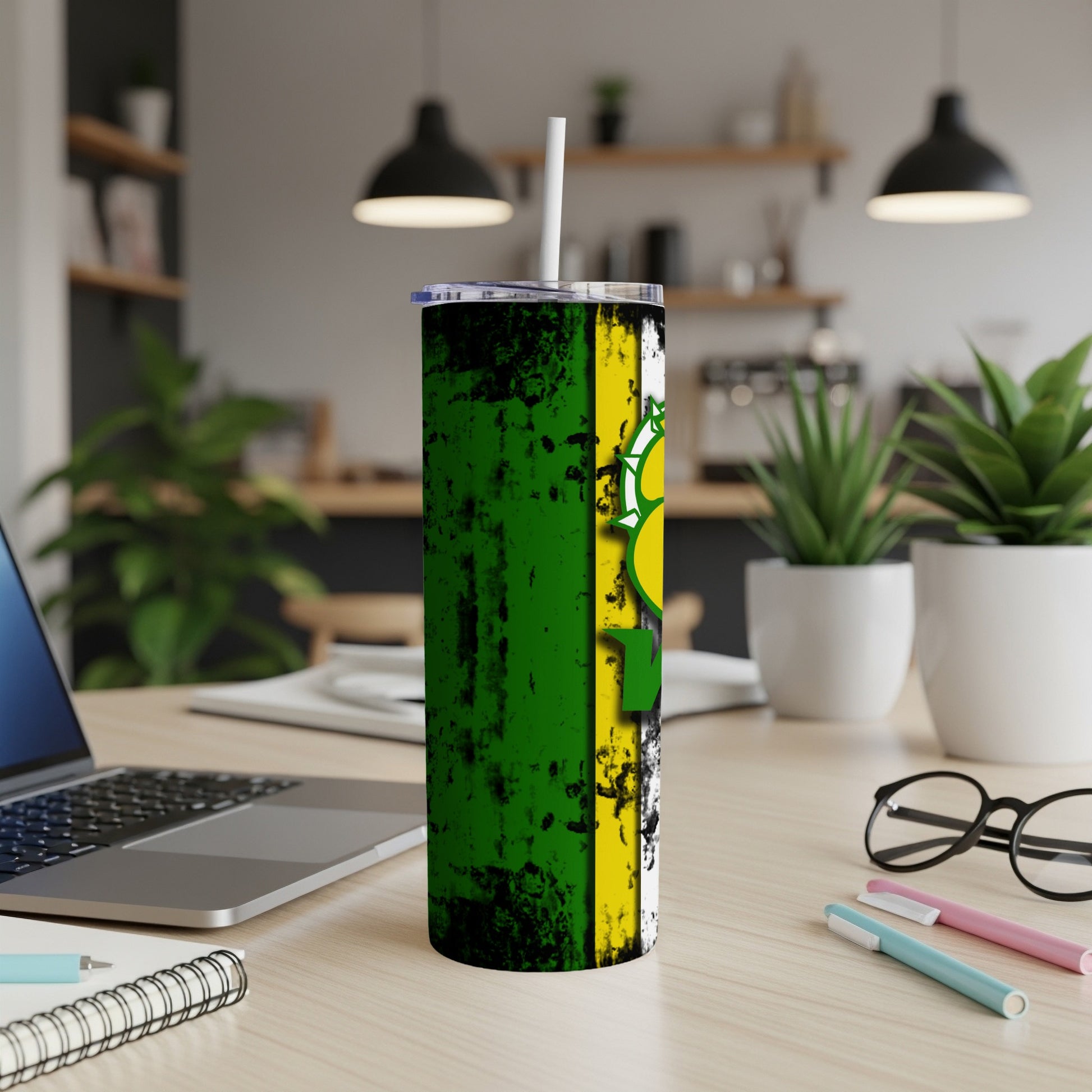 Tall tumbler with green, yellow, and white distressed design and straw.