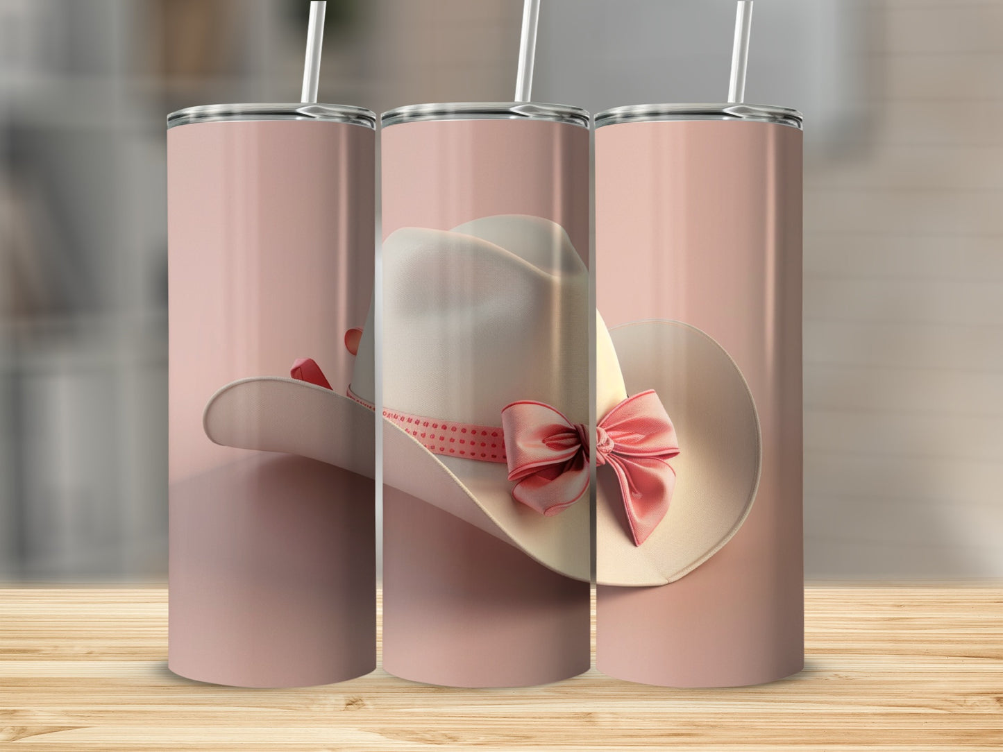White cowboy hat with pink ribbon and bow on a pink tumbler.