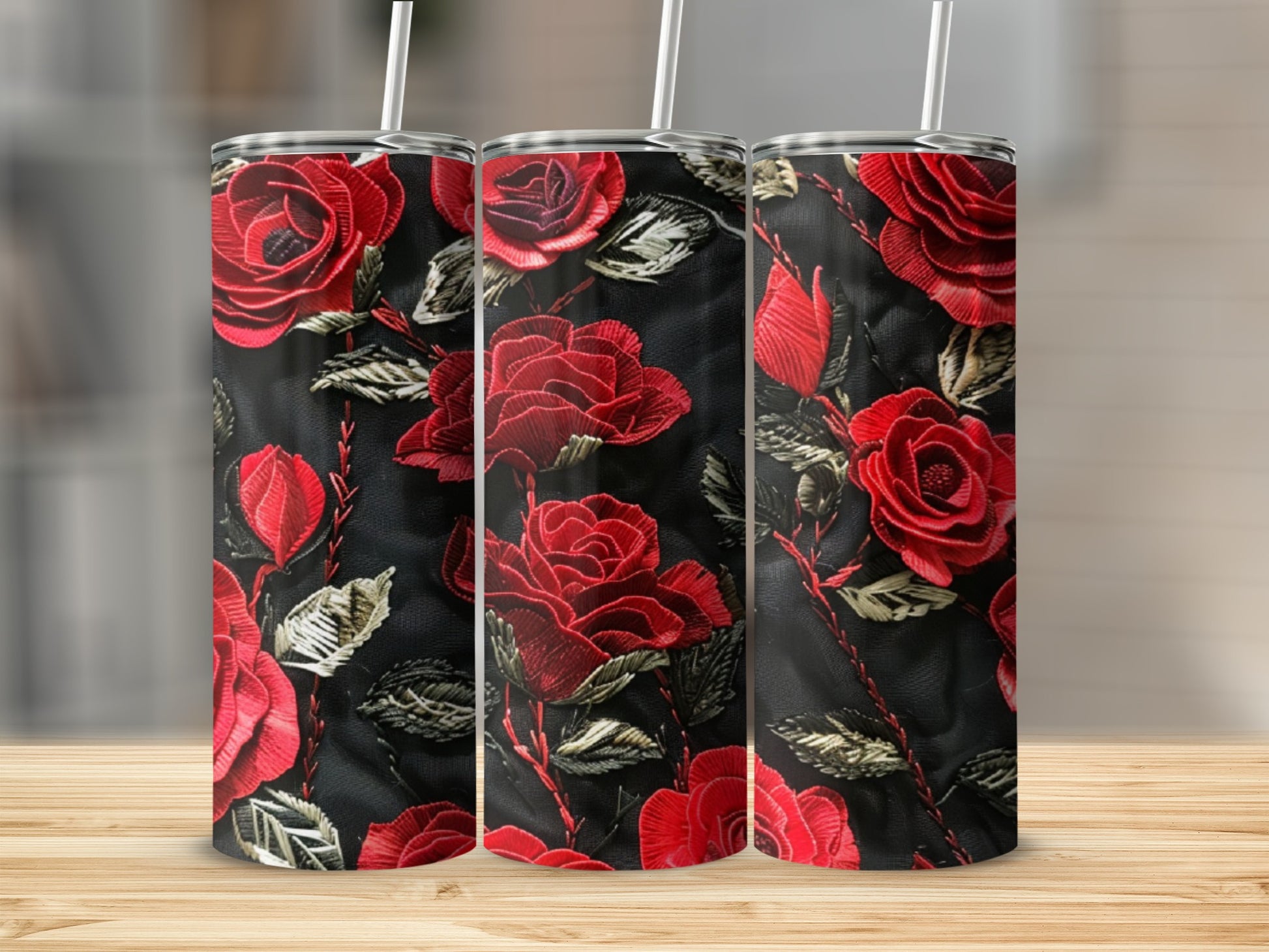Three tumblers with red rose embroidery on black background.