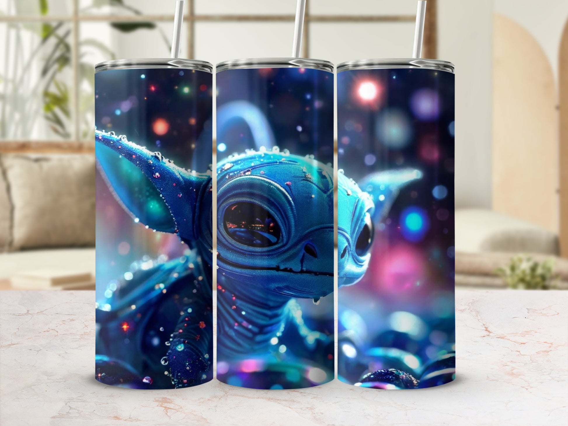 Blue alien character with large eyes and glitter effect on three tumblers.