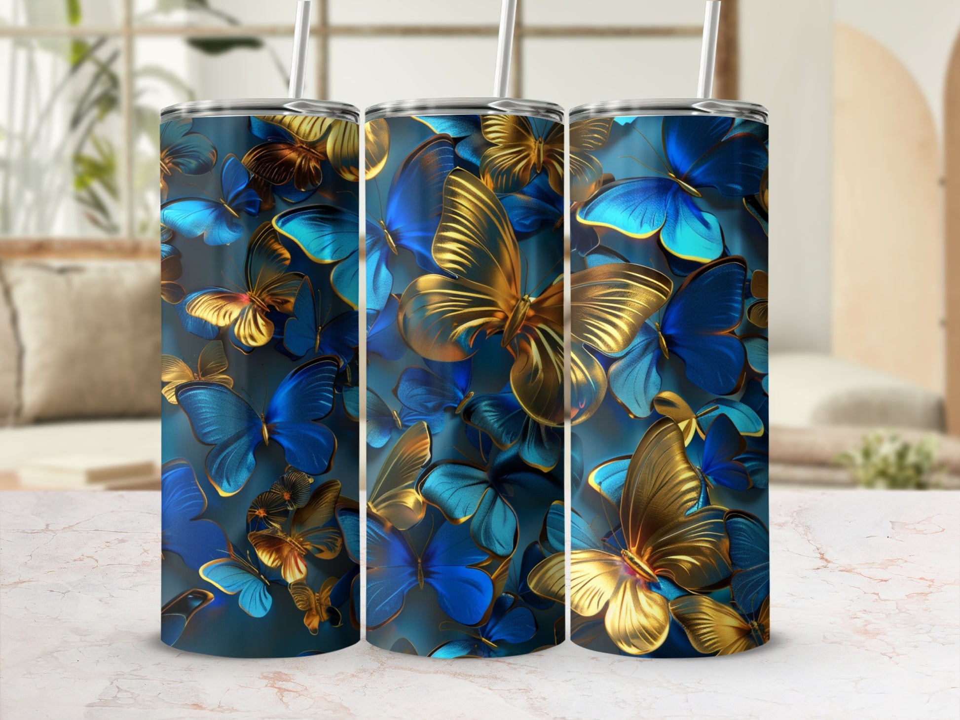 Tumbler with blue and gold butterflies on a marbled surface.