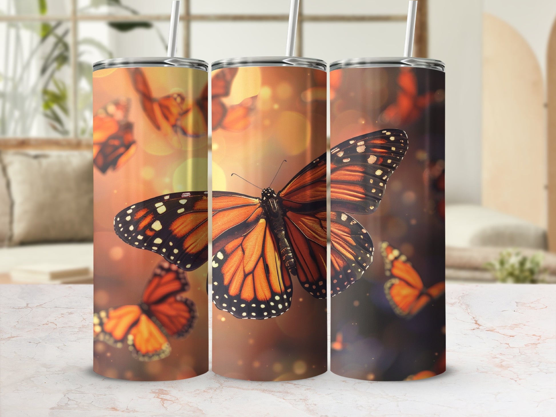 Three tumblers with monarch butterflies and bokeh background.