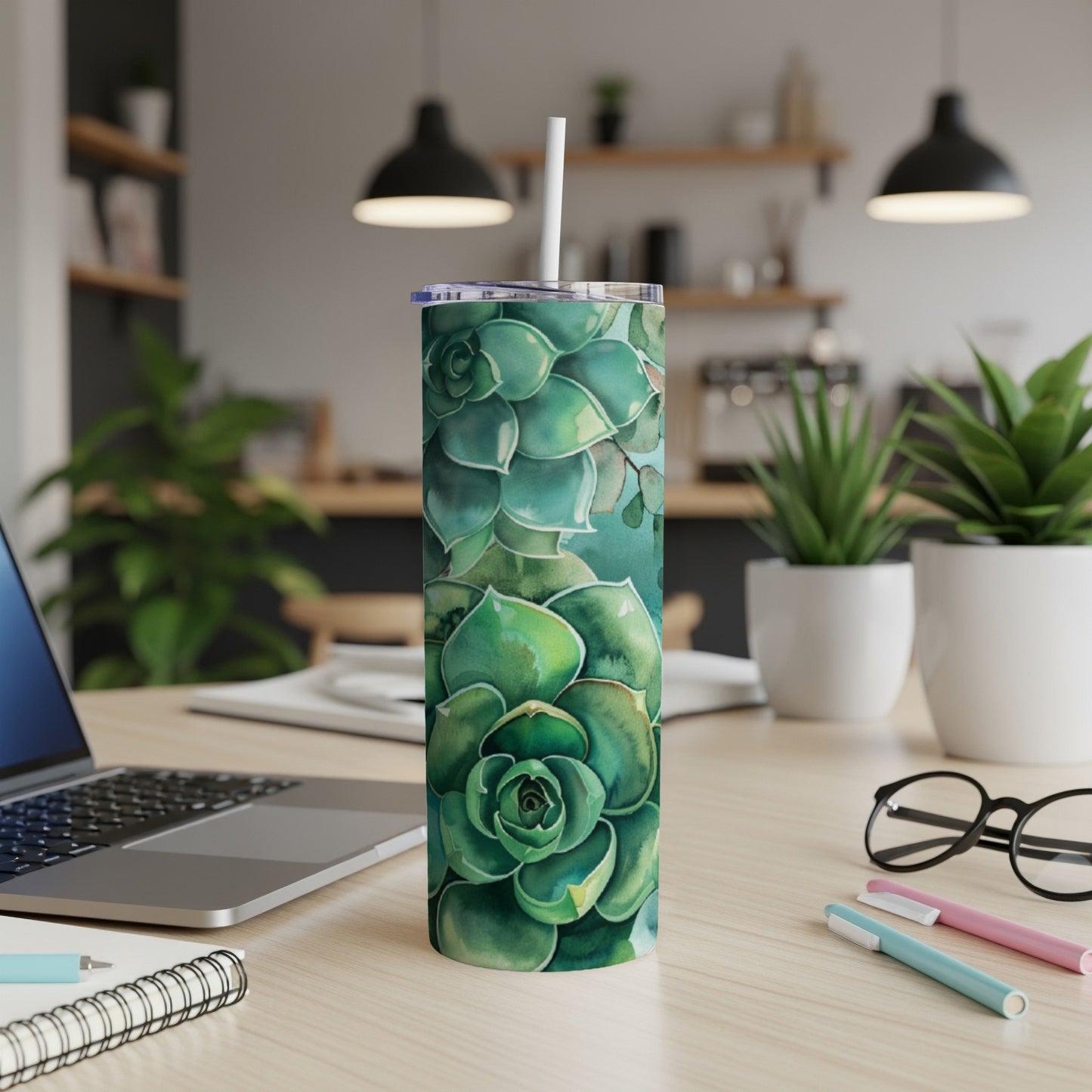 Green succulent pattern on a white skinny tumbler with a straw.