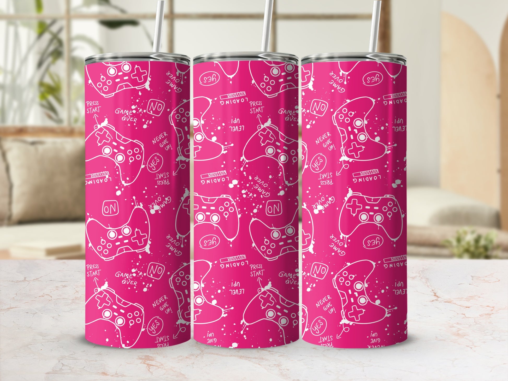 Pink tumbler with white controller and gaming icons on a white background.