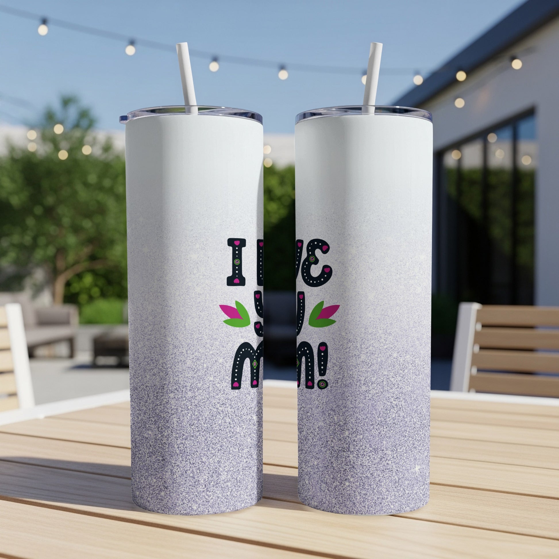 Two tall tumblers with "I love you mom!" design on a patio table.