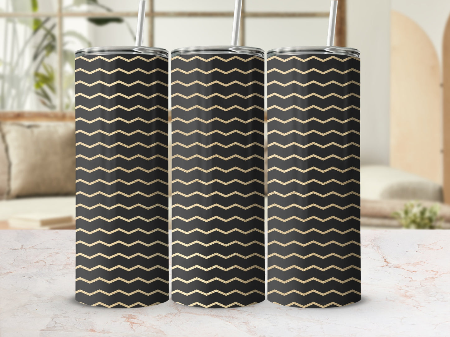 Three tumblers with black and gold chevron pattern, featuring metal straws.