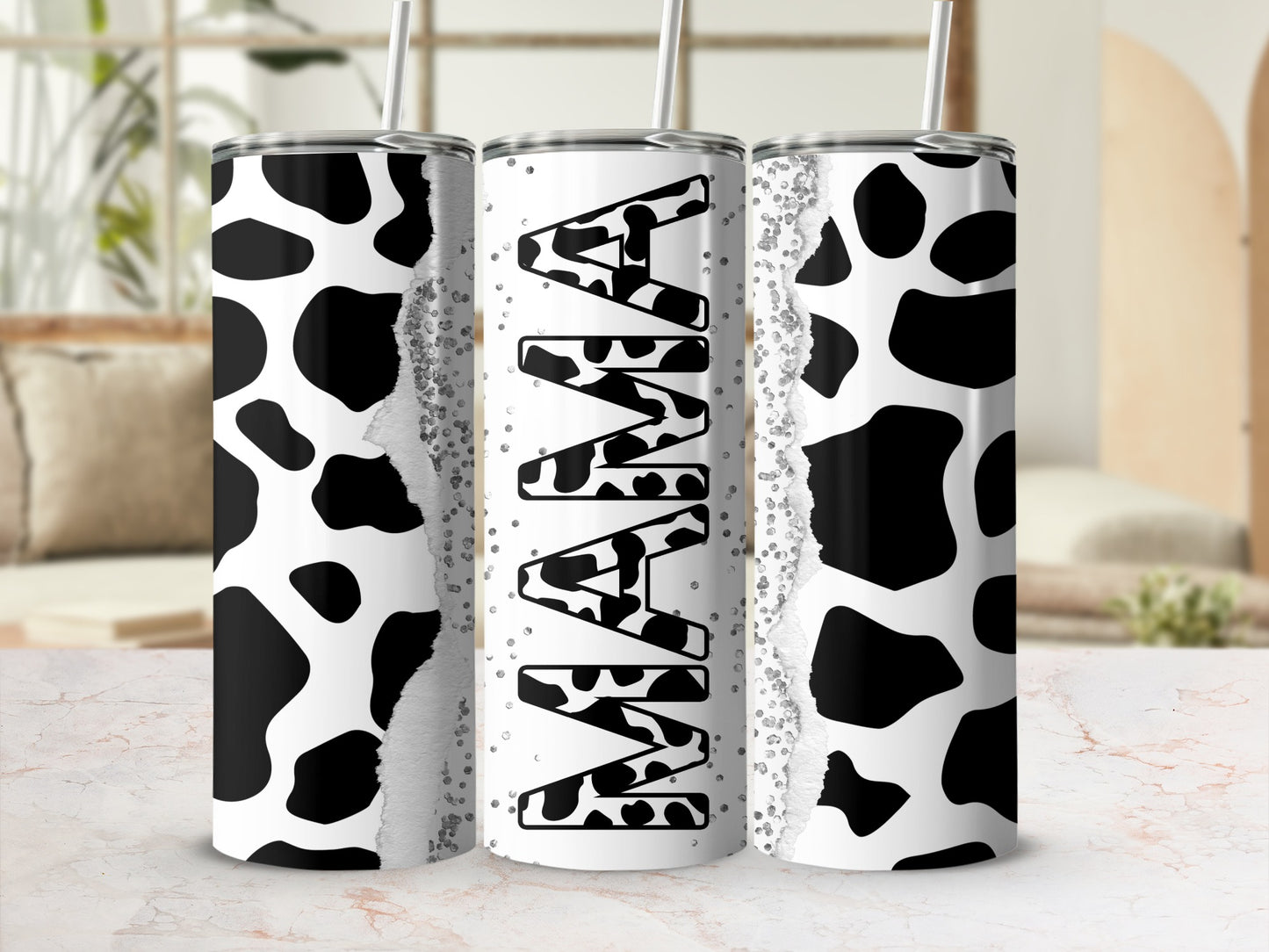 Cow print tumbler with "MAMA" text and glitter accents.