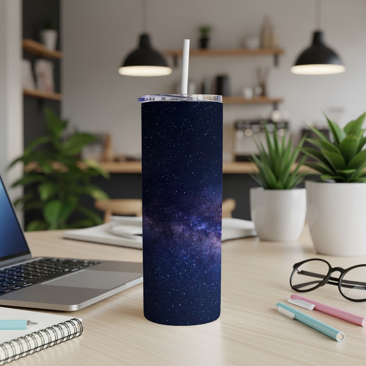Tall tumbler with a starry night sky and galaxy pattern, featuring a white straw.