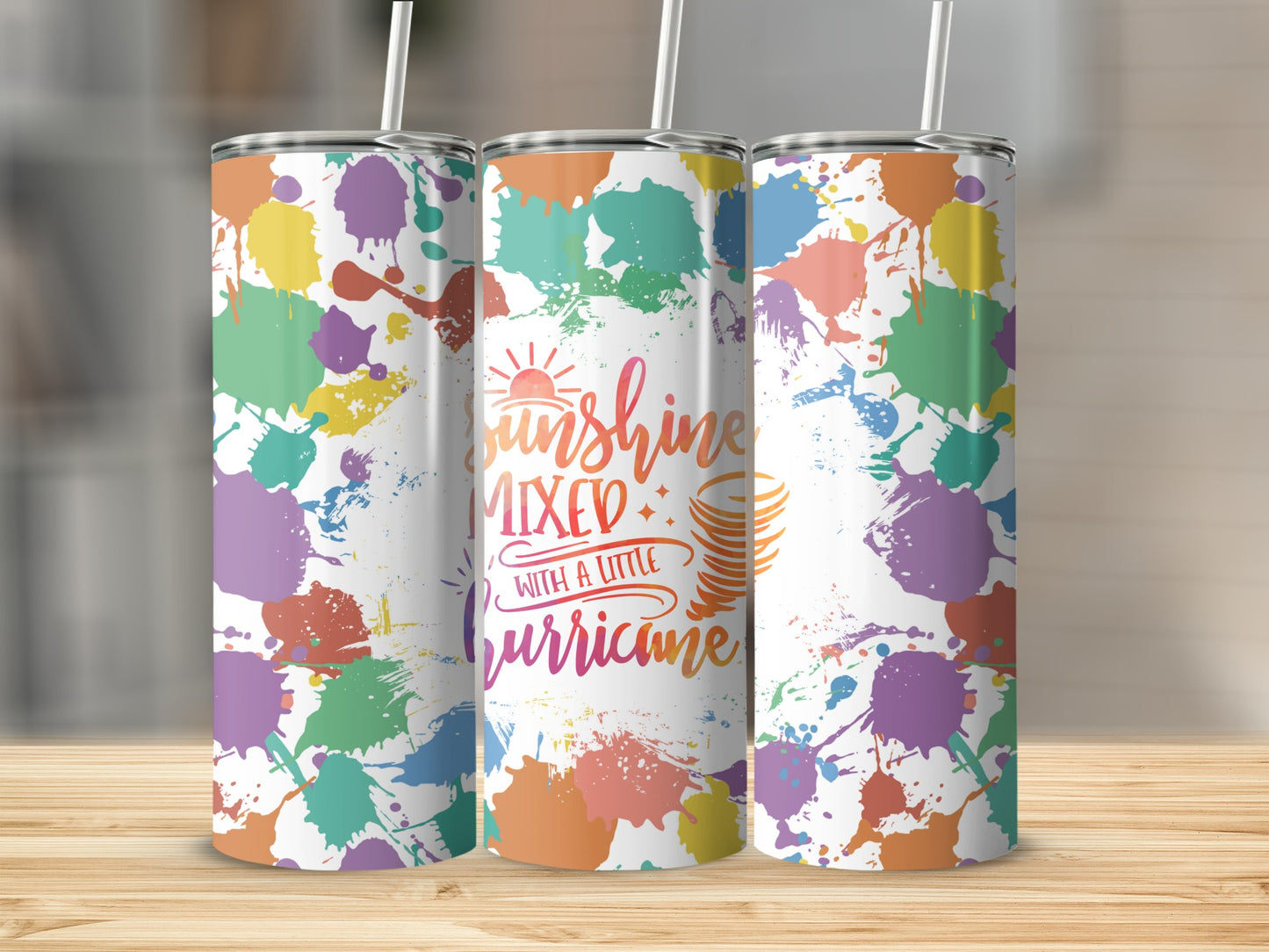 Three tumblers with colorful paint splatters and "Sunshine Mixed with a Little Hurricane" text.