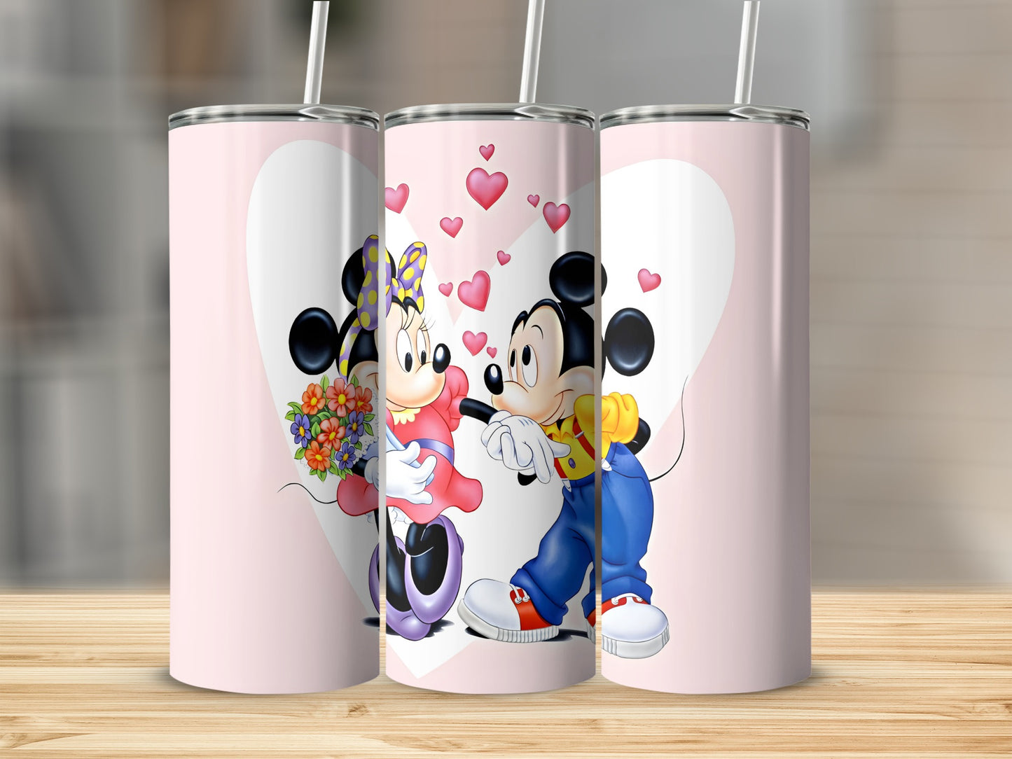 Minnie and Mickey Mouse embrace with hearts and flowers on a pink tumbler.
