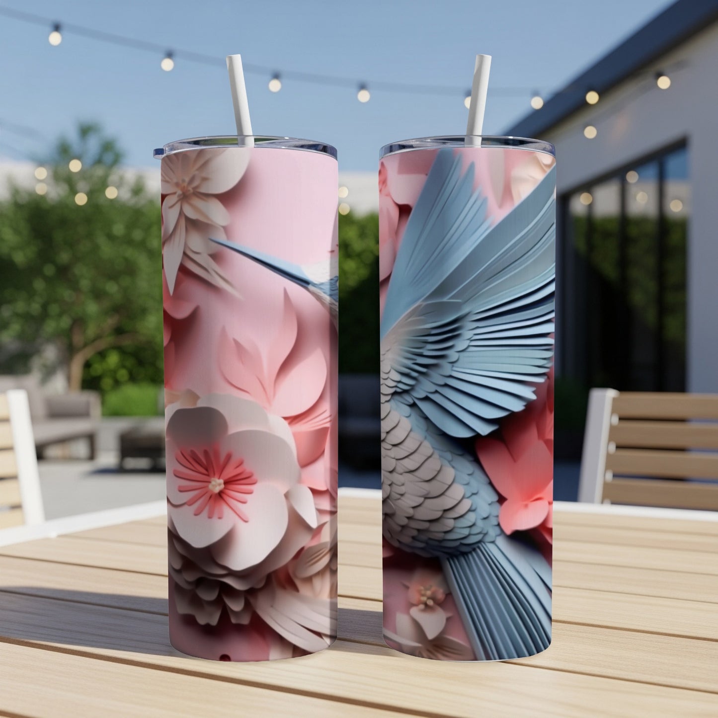 Two pink and blue hummingbird tumblers with floral designs.
