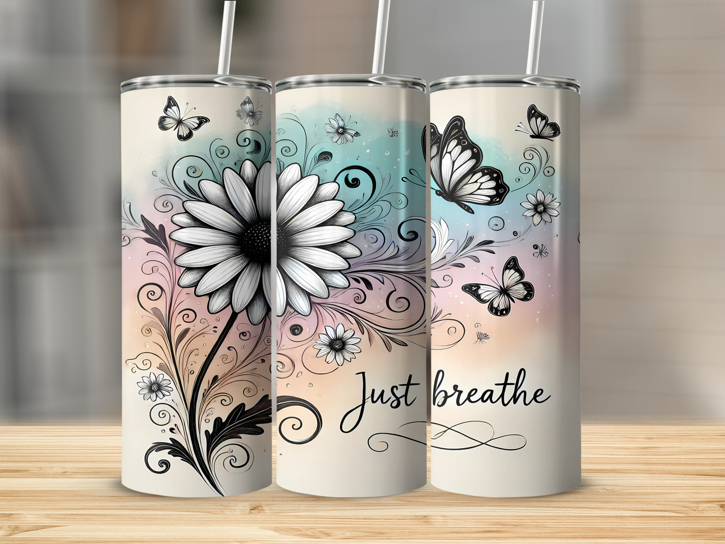 Three tumblers with a floral and butterfly design, one says "Just breathe".